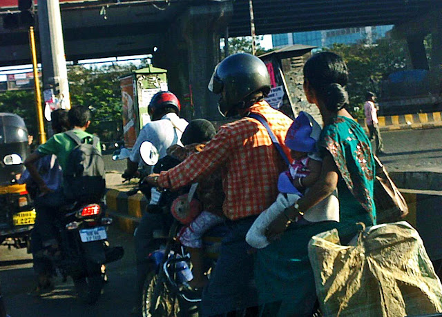 couple with toddler and baby on bike