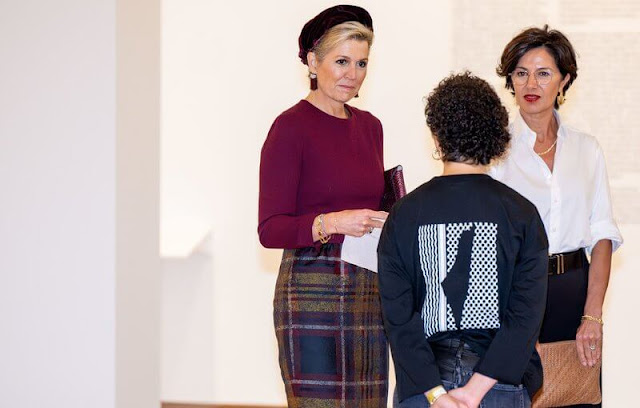 Queen Maxima wore a burgundy top by Natan. She wore a wool midi skirt by Natan. Günay Uslu and visual artist Jonas Staal