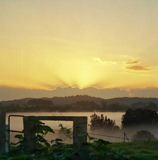 Golden sunrise over misty valley