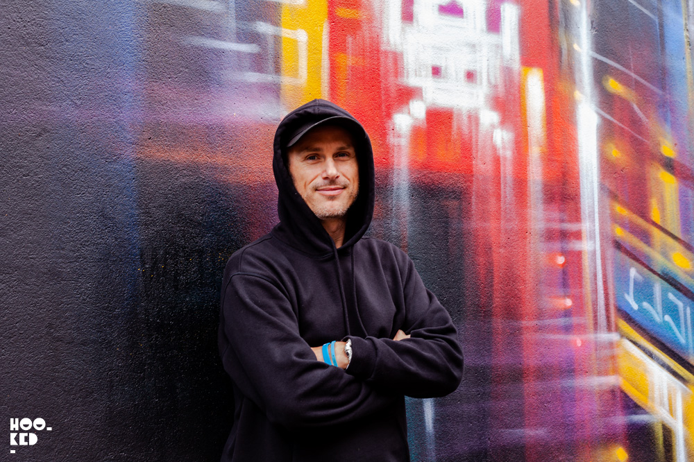 Portrait of artist Dan Kitchener in front of his finished mural at Waterford street art festival