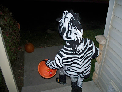 Lilly running out the door on a night of trick or treating