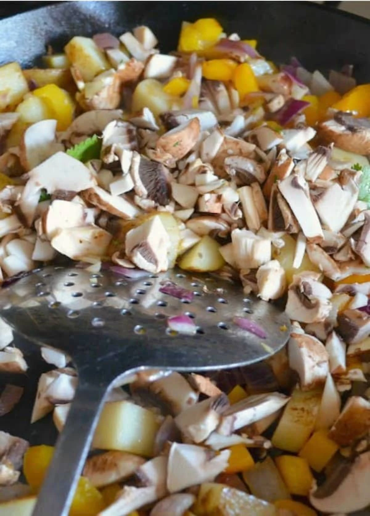 Add sliced mushrooms to breakfast potatoes for Breakfast Burrito Recipe.
