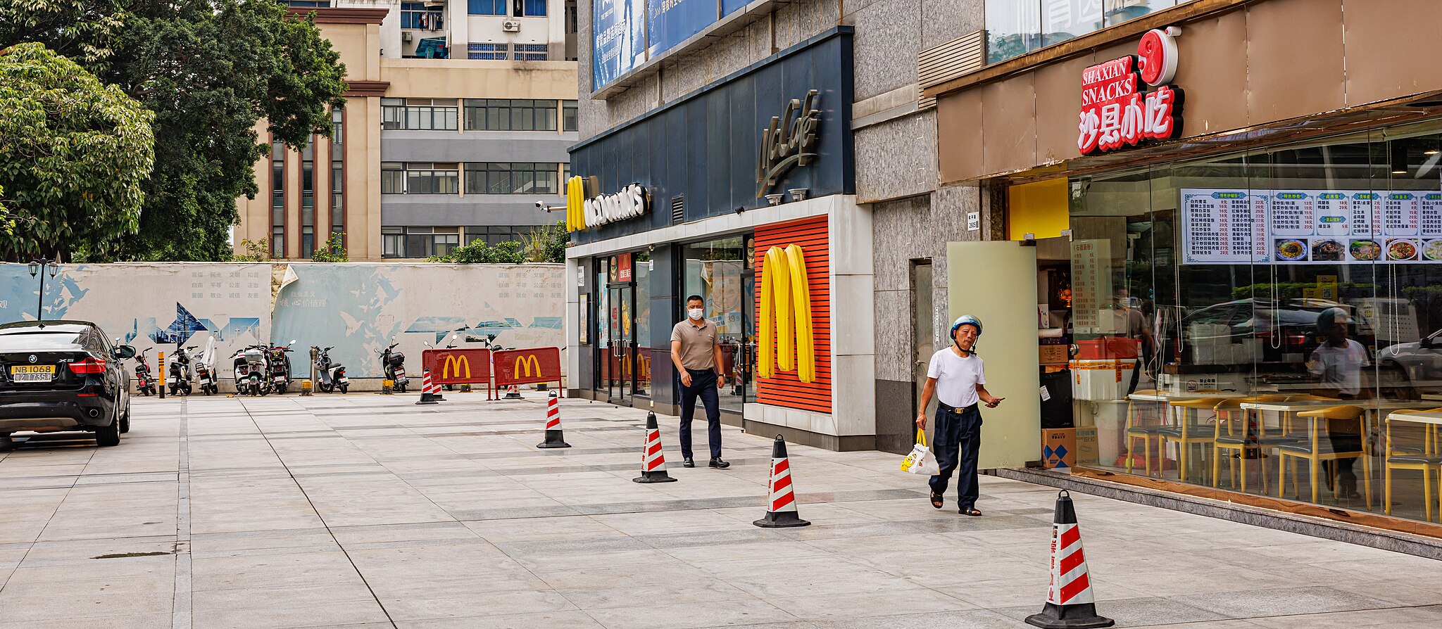 McDonald’s restaurant near an eating area with customers getting orders to-go.