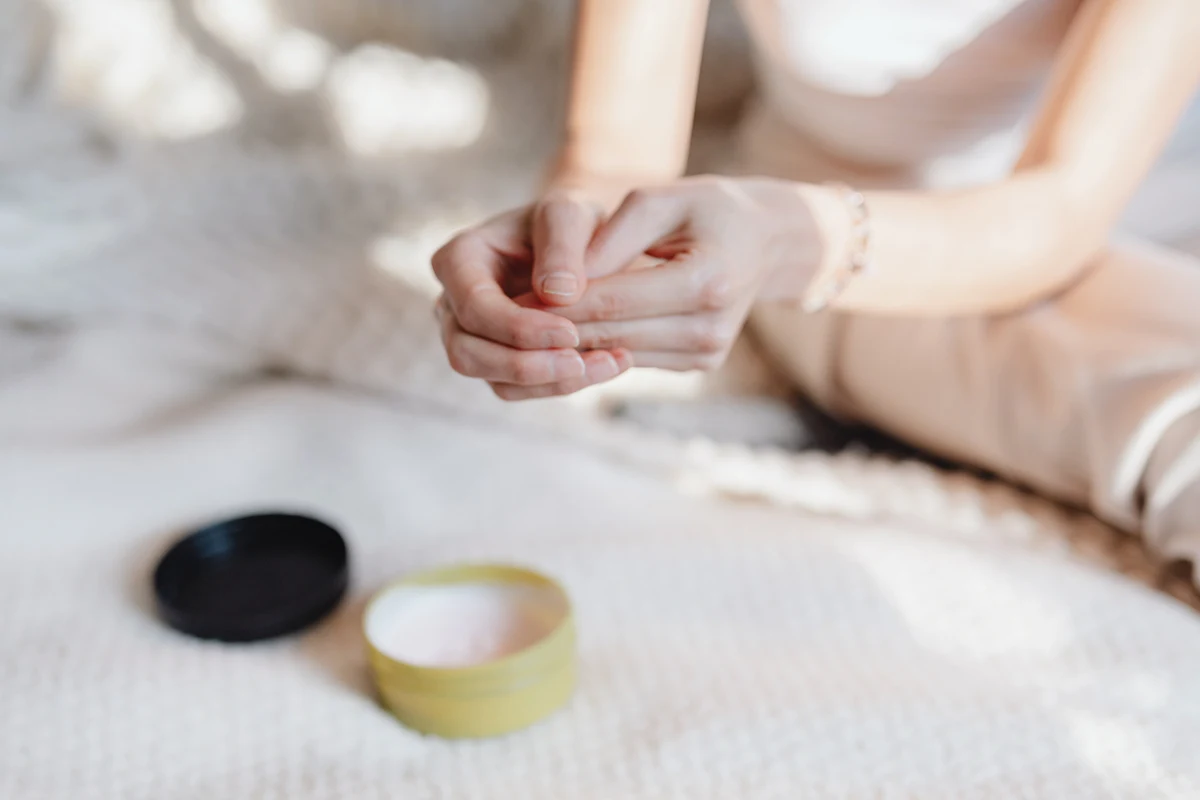 woman applies cream on her hands