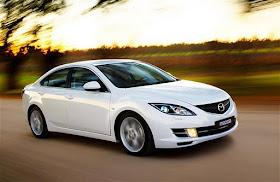 Front 3/4 view of 2012 Mazda 6 being driven on country road