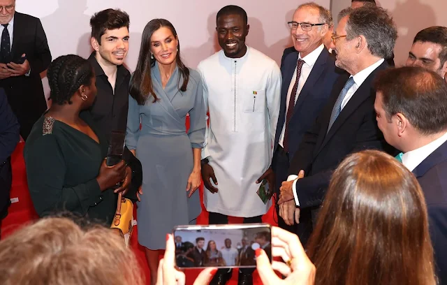 Queen Letizia wore a wrap around dress with side lacing by Adolfo Dominguez. Furla bag and Magrit pumps