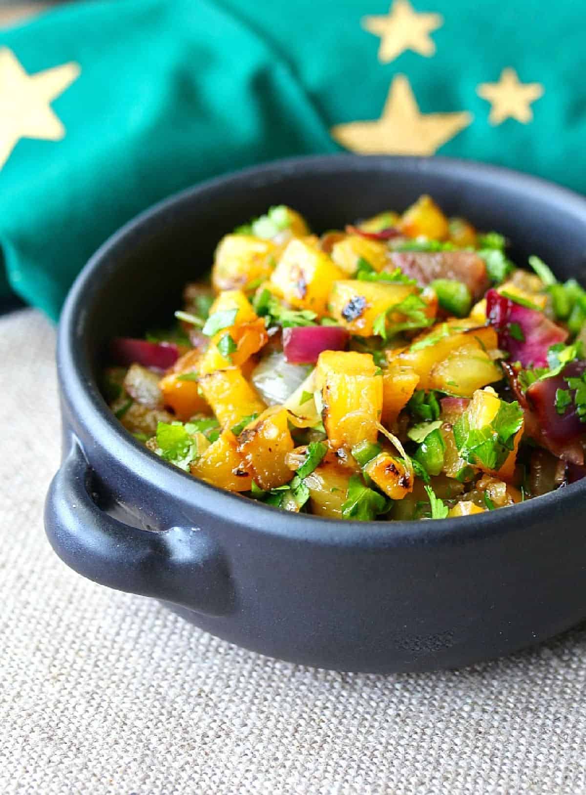 Grilled Pineapple and Red Onion Salsa in a black bowl.