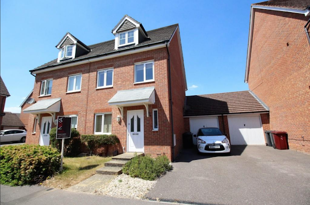 Red semi-detached brick house with a garage