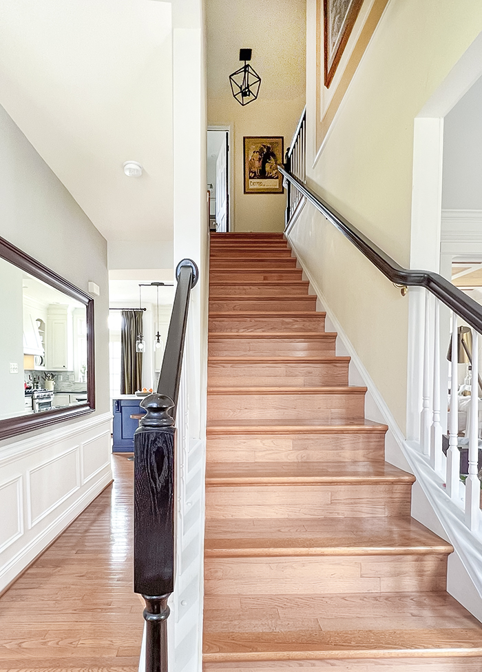 a red oak staircase and foyer in need of a makeover