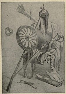 Figura em preto e branco com escudo, espada, armadura e outros utensílios de proteção