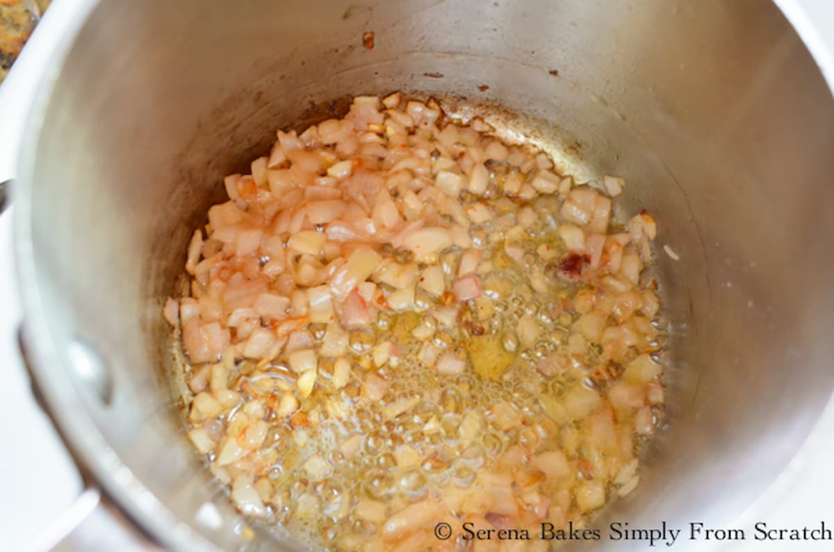 A down shot of shallots being caramelized in a sauce pan.
