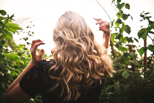 Woman Brushing her Hair with her Hands