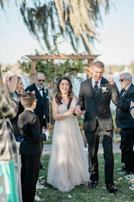 bride and groom holding hands after ceremony