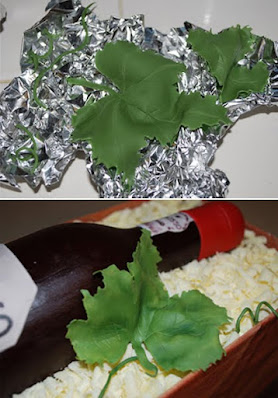 Drying fondant grape leaves over foil for shaping and dusted them to look real