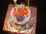 Tinkerbell cake comes eqiuped with fondant flowers and mushrooms and pixie .