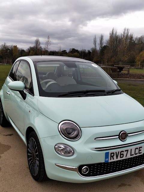 Fiat 500 car under cloudy skies