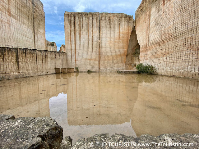 The bottom of the remnants of giant sandstone quarries overflown with water.