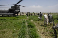 Soldiers transport a detainee found with a weapons cache in Sabari, Afghanistan during an air assault mission in support of Operation Champion Sword.