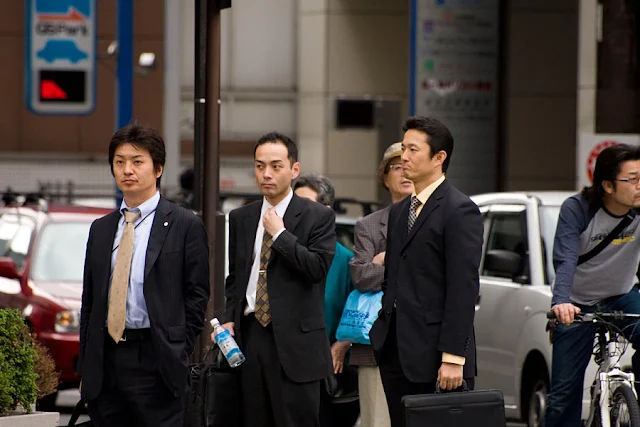 Image Attribute: Japanese salarymen (office workers), wearing the mandatory suit (© 2008 / Chris Gladis, under a Creative Commons license)