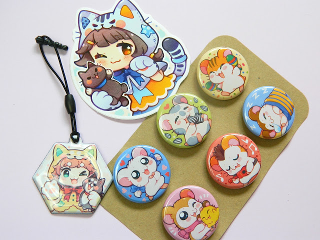 A haul from a store called Mi-eau: button badges, stickers and a charm 