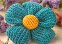 http://www.letsknit.co.uk/free-knitting-patterns/quick_knit_flower_brooch