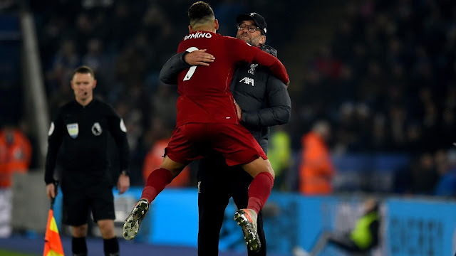 Roberto Firmino enjoys that winning feeling and jumps for joy into the arms of Jurgen Klopp after Liverpool thrash Leicester City 4-0 at the King power stadium