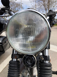 Horn mounted under Royal Enfield headlight.