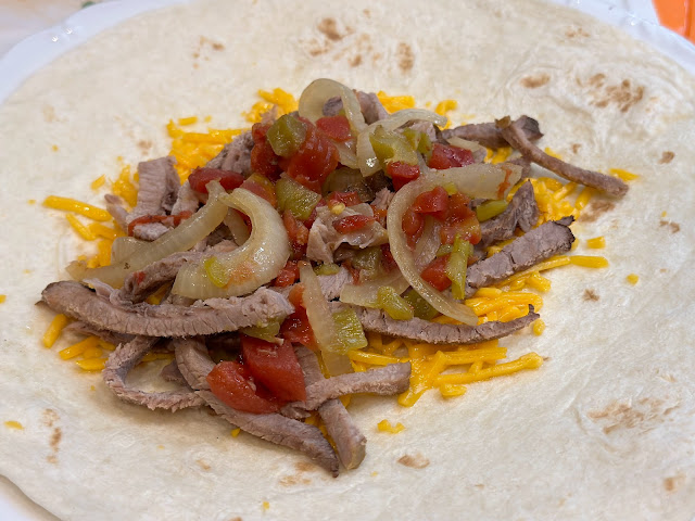 fajita filling with melted cheese on tortilla