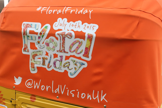 A tuk tuk at RHS Hampton Court flower show advertises World Vision's Floral Friday