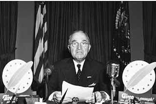 President Harry S. Truman talks amid a TV address from the Oval Office 