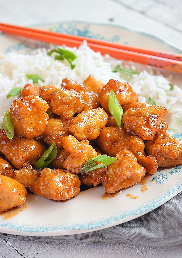 another look of a white plate with Chinese orange chicken served with rice