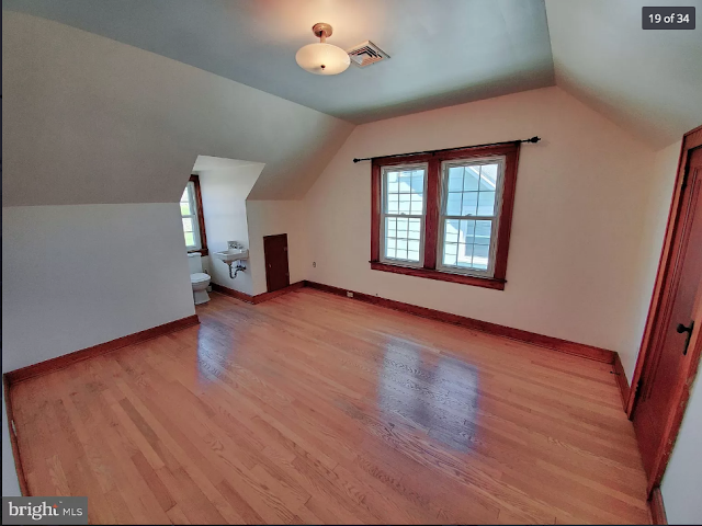 bedroom with oak wood floors and craftsman trim color photo of small white cape style house with peak roof porch  and small dormer Sears Lorain • 270 Broad Street, Landisville, Pennsylvania