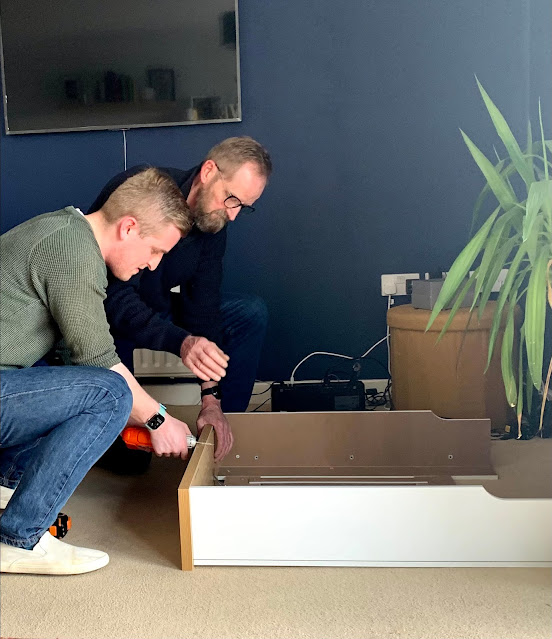 men building flat pack furniture