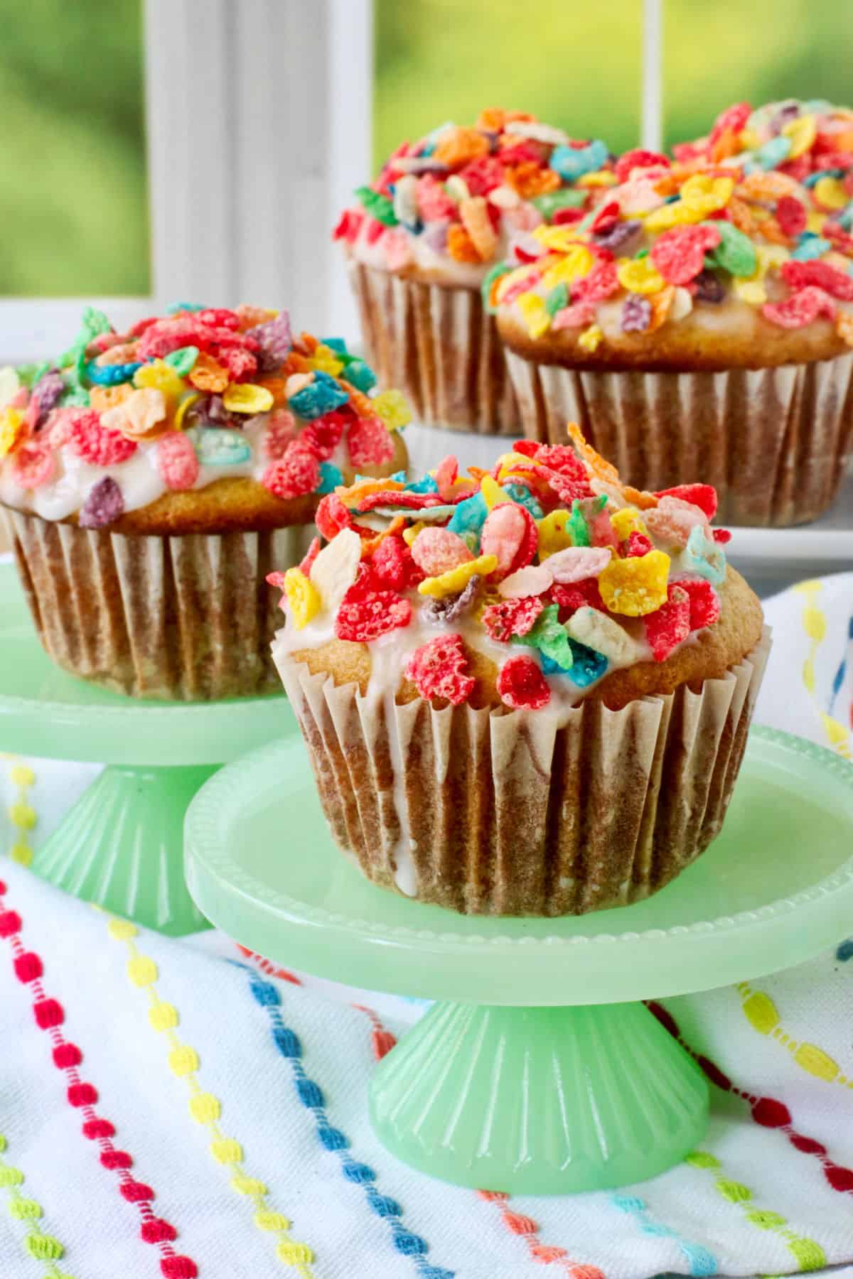 Cereal Milk Muffins on green individual cake stands.