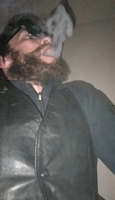 From Superior POV Oregon Leather boy releases smoke flowing upward wearing dark skin against his pale