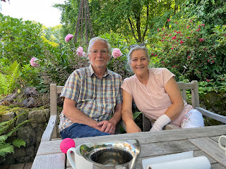 Bill and Bente sitting outside in their garden patio