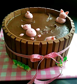 as happy as a pig in mud, pigs, kit kat cake, dessert, chocolate, marzipan pink pigs in barrel, kitkat, pink gingham ribbon