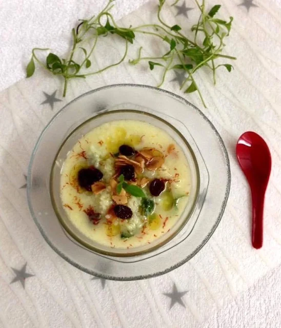Indian-style rice pudding with coconut milk, saffron, sugar, ghee-fried almonds, blackcurrants, and stevia leaves.