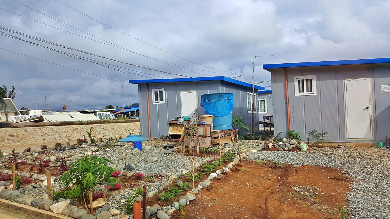 temporary shelter units where residents attempted to make little gardens in their front yards