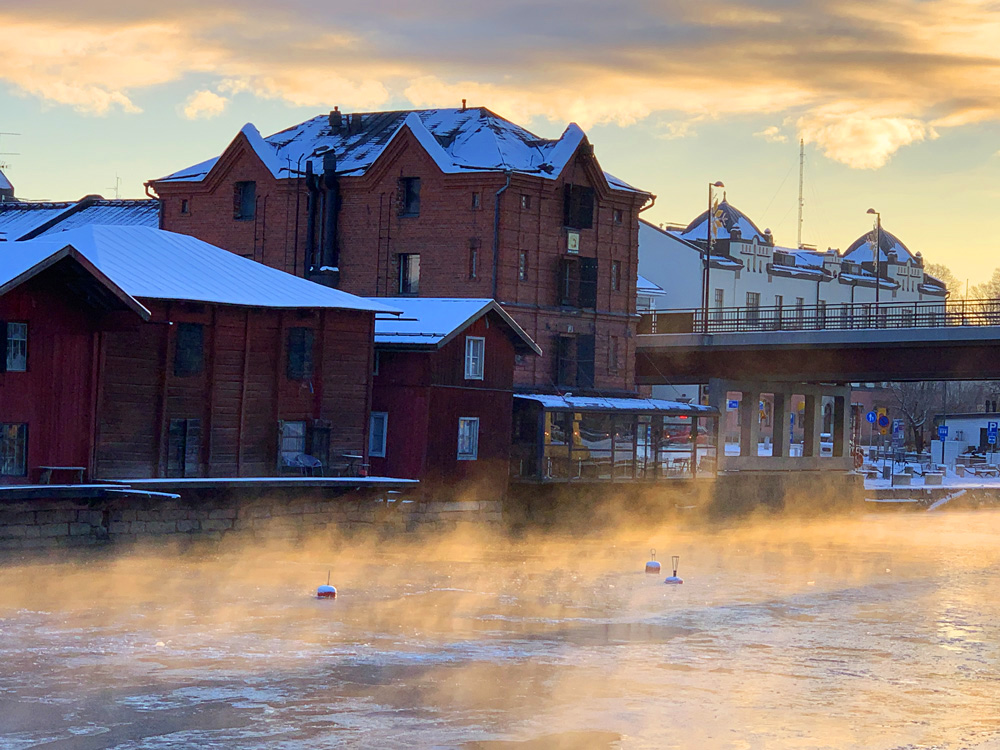 River mist above the river and by red the warehouses