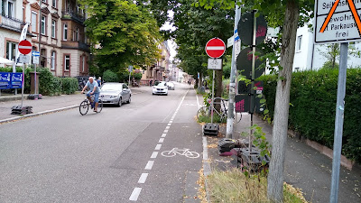 A German street with a no entry except cycles signs