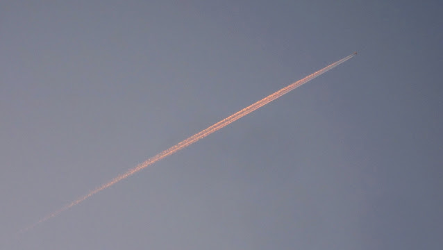 contrail away from sun