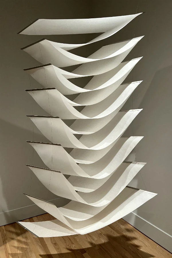 hanging sculpture composed of connected white paper sheets