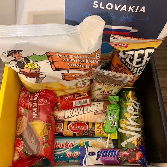 Box of Slovakian snacks, including chocolate bars, crisps and can drink