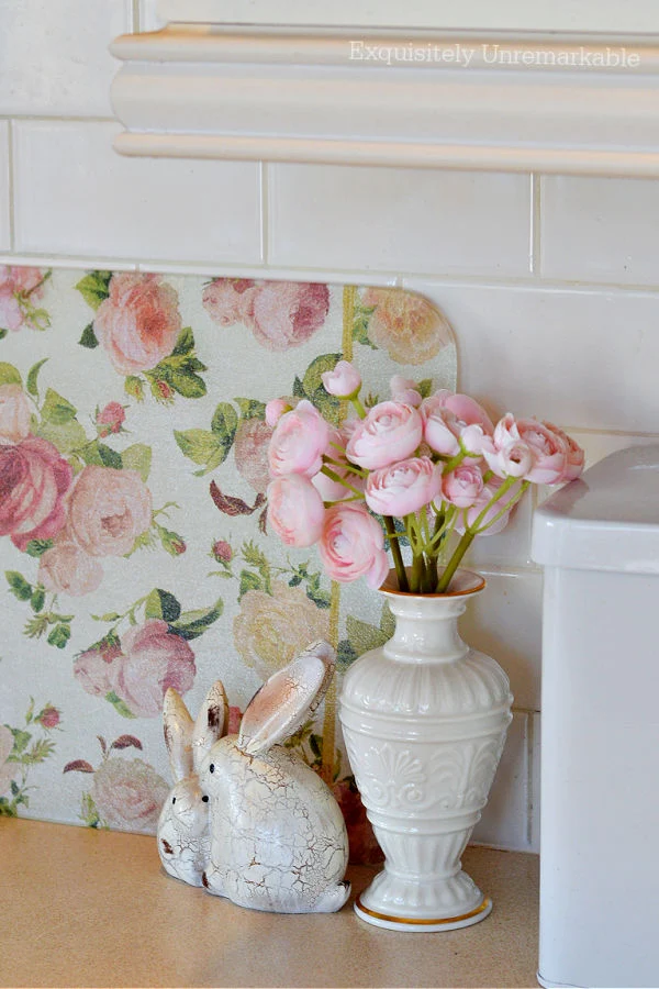 Cottage Style Cutting Board on a countertop with spring bunny figurine and pink flowers