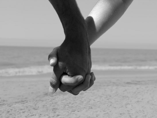 Young couple holding hands, walking