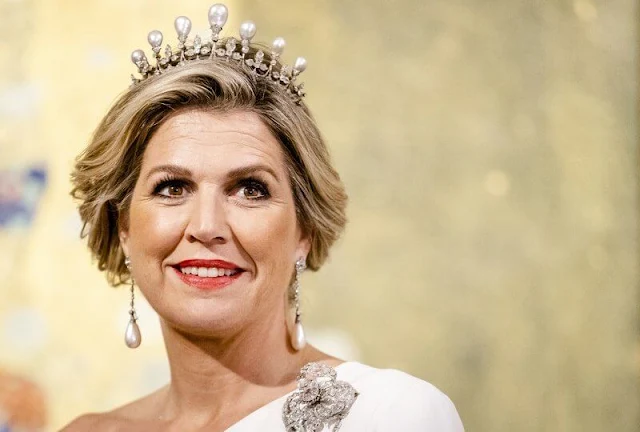 Queen Maxima wore a white one-shoulder stretch cady gown by Stella McCartney. Antique pearl tiara, earrings and brooch