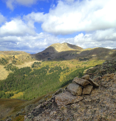 Mountain cairn with peak in the background