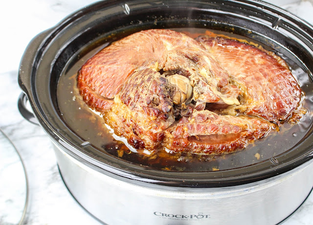 whole ham in an oval slow cooker.