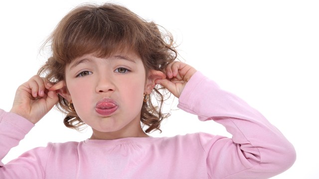 4 Year Old Girl Blowing Raspberry and Holding Ears